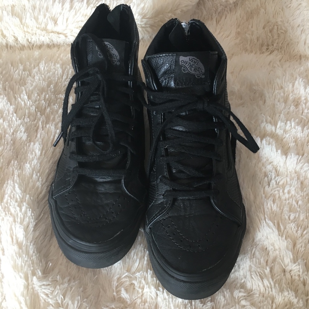 Vans black leather high top sneakers.